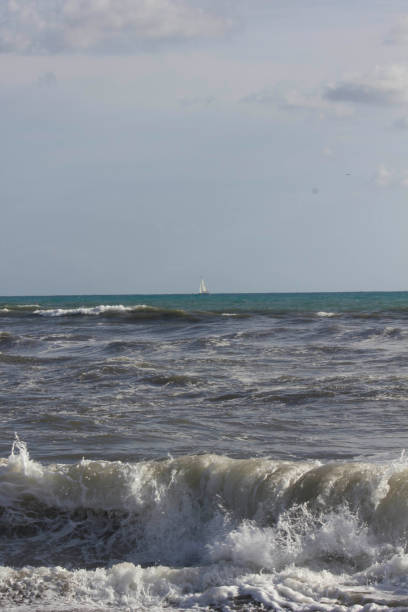 istock Rough seas in Marina di Massa, with a sailing boat 866021294