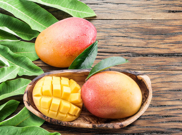 istock Mango fruits  on the old wooden table. 866028162