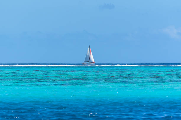 Tahiti in French Polynesia, panorama between sea and sky in the lagoon, beautiful sailing boat