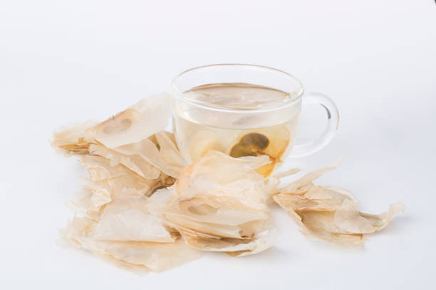 Oroxylum indicum seed and cup of tea. Oroxylum indicum seed is used in traditional Chinese Medicine. It is a Chinese herbal medicine and also can be used to make tea drink. coelacanth photos stock pictures, royalty-free photos & images