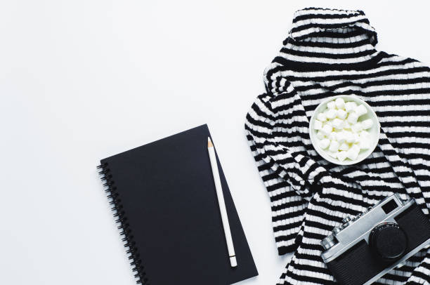 istock Striped women's blouse old camera and sketchbook on a white background 866033968