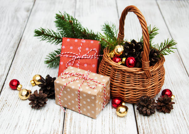 istock Christmas gift boxes and fir tree branch in basket 866035142