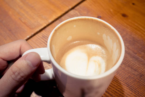 istock Close-up Hands Holding an Empty Cup of Coffee 866035602
