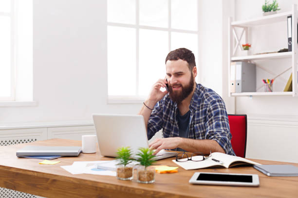 istock Young businessman has a mobile talk in modern white office 866039904