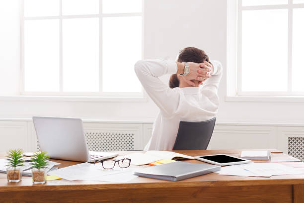 istock Happy and relaxed businessman with laptop in modern white office 866040636