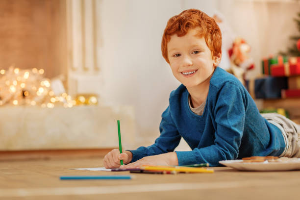 istock Cheerful kid drawing and smiling into camera 866040756