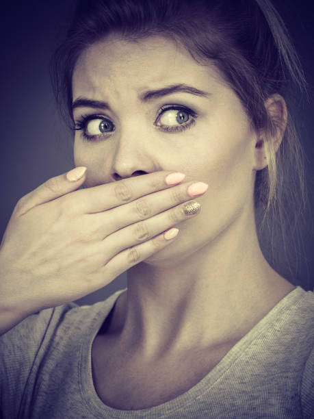 istock Woman covering her mouth with hand 866043928