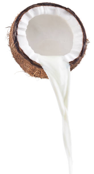 istock Coconut milk pouring out of coconut fruit. White background. 866046588