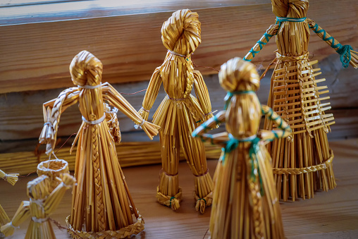 Straw doll. Vintage children's toys handmade from dried straw for rural children.