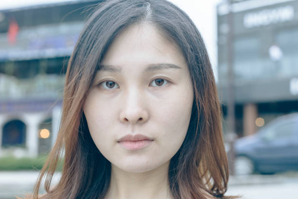 istock closeup of asian woman with blank expression looking at camera 866048436