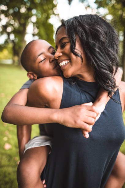 istock mother and son piggyback in the park 866049030