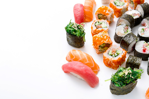Salmon and philadelphia sushi rolls - asian food restaurant delivery, platter set on white background, copy space