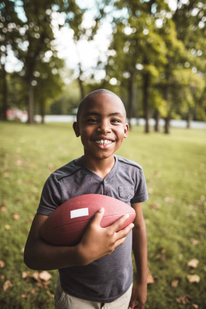 little kid happiness with football ball little kid happiness with football ball indianapolis photos stock pictures, royalty-free photos & images