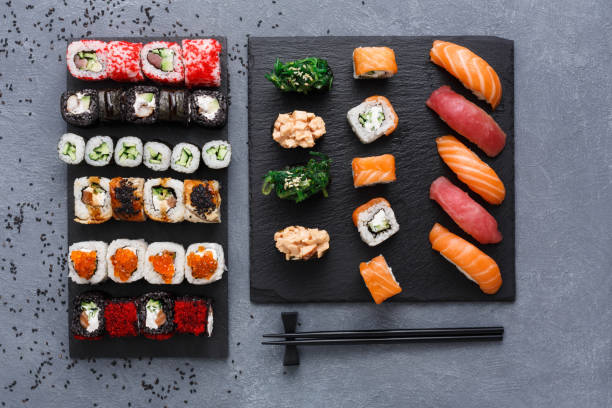 istock Top view set of sushi maki and rolls on rustic grey and sesame background 866051736