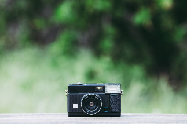 istock Retro camera and green blur background 866052684