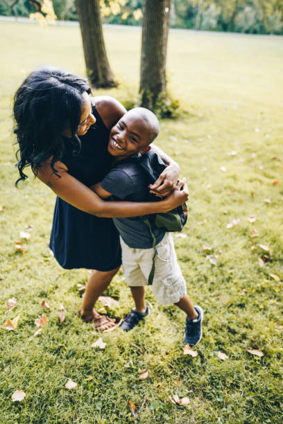 istock mother and son embracing in the park 866052696