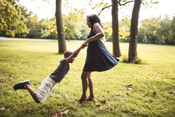 istock mother and son playing in the park 866053048