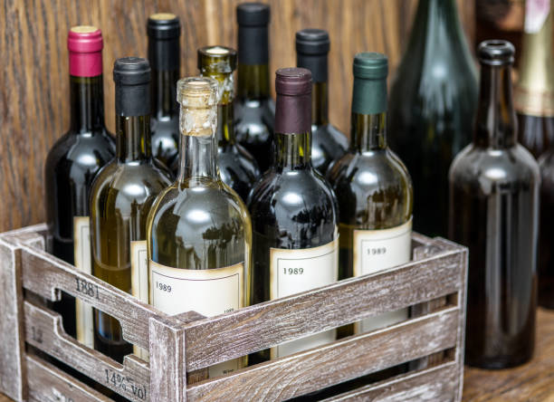 istock Old wine bottles in a wooden crate. 866053230