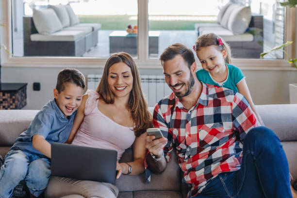 istock Young happy family using wireless technology at home. 866060032