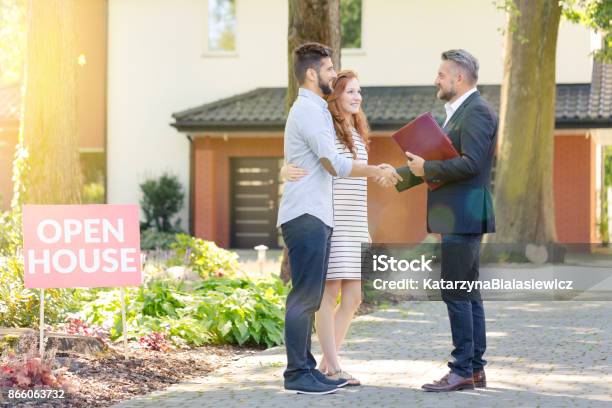 Real Estate Agent Welcoming Visitors Stock Photo - Download Image Now - Open House - Real Estate, Real Estate, Real Estate Agent