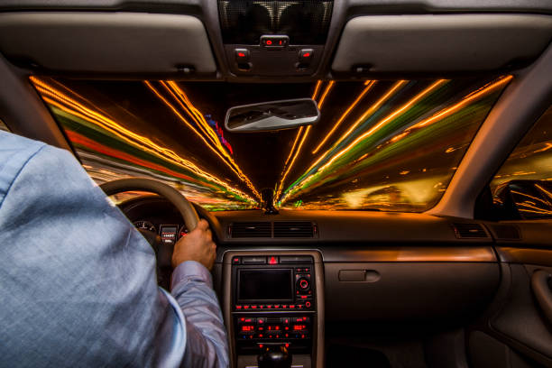 Inside a car - driving fast at night stock photo
