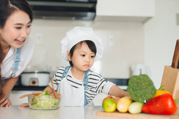 istock Mother with her daughter in the kitchen cooking together 866065076