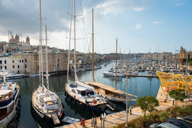 Boats and yachts anchoring in Valletta, Malta VALLETTA, MALTA - AUGUST 23, 2017: Boats, ships and yachts anchoring in Birgu harbor, one of the biggest port from the Three Cities of Malta coconut crab stock pictures, royalty-free photos & images