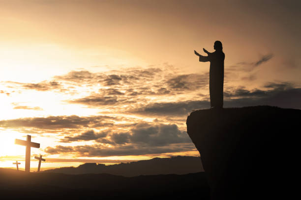 istock Silhouette of man facing the cross and praying 866073438