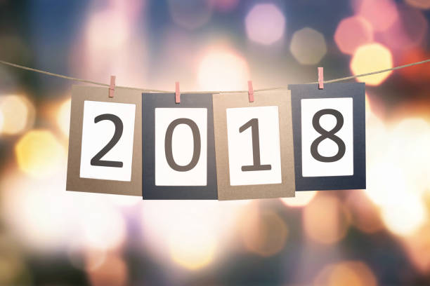 istock 2018 number on paperboard for New Year hanging on rope 866077746