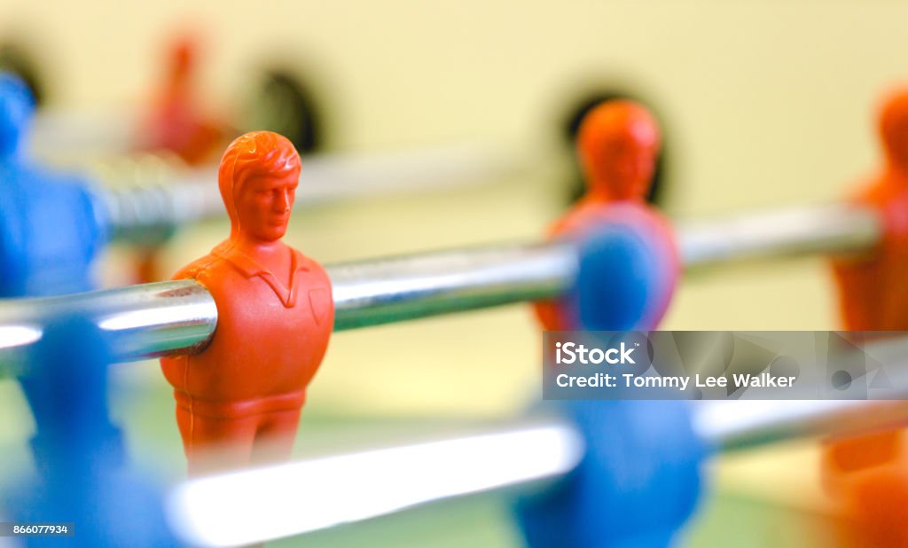 Table football, fusbal red and blue players in macro view Table football, foosbal red and blue players in macro view. Low angle detailed view with selective focus and shallow depth of field. Foosball Stock Photo