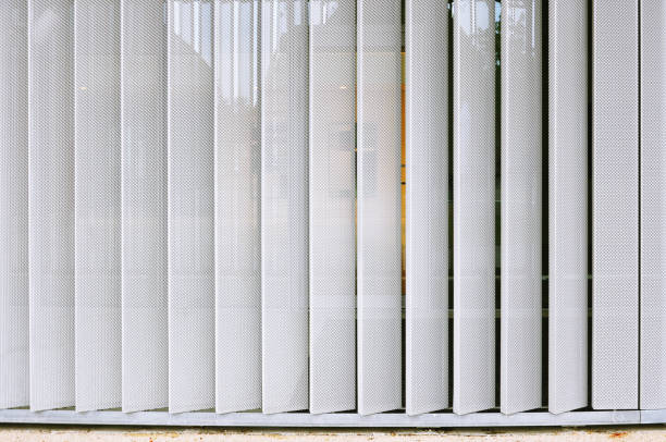 istock White modern structure of metal perforated vertical panels. 866078464