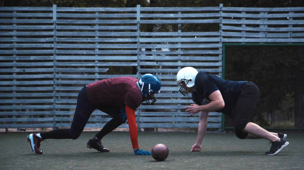 istock Two helmeted football players 866079196