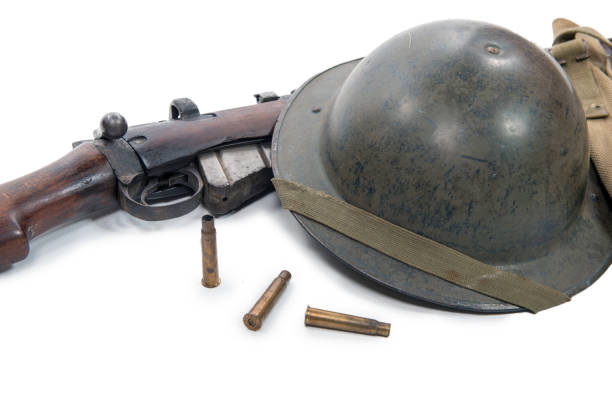 istock a british helmet and rifle of World War II 866079228