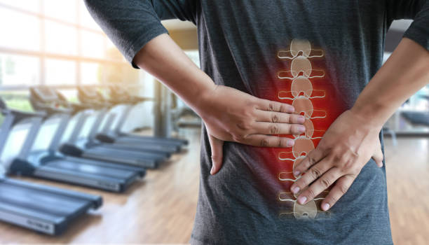 young man feeling suffering  lower back pain  pain relief concept - low back imagens e fotografias de stock