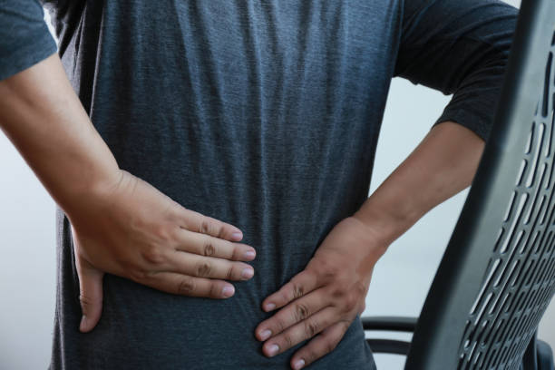 istock young man Feeling suffering  Lower back pain  Pain relief concept 866081084