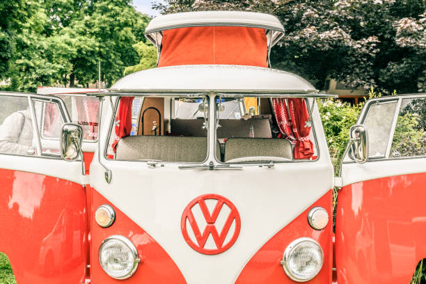 1950s Volkswagen Transporter T1 campervan with open doors parked in a park. The Volkswagen Transporter is a popular van to use as a camper and was delivered originally as a camper van, but many have been converted later. The car is on display during the 2016 Classic Days event at Schloss Dyck.