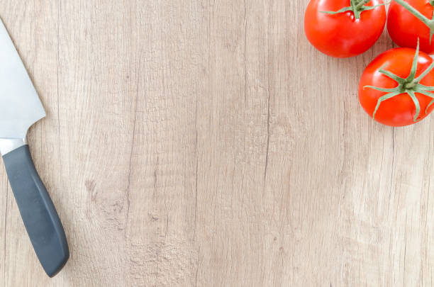 istock Tomato with knife on wooden table 866091418