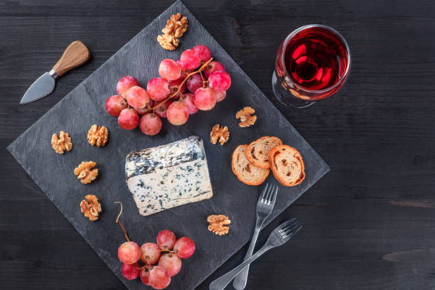istock Blue cheese and grapes on black with copy space 866095106