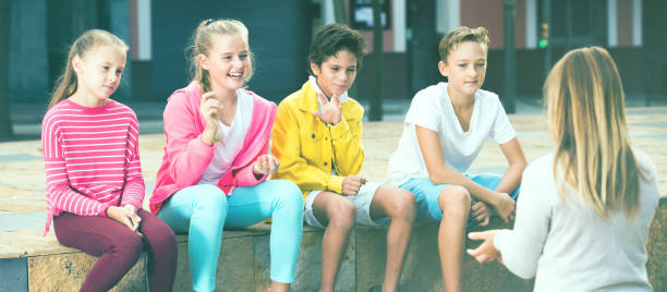 istock Company of children are communicating on walk 866096836