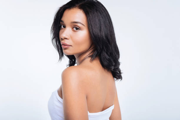 istock Beautiful woman in white tank top posing 866097096
