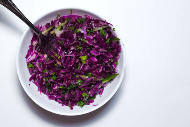 istock Fresh vegetables salad with purple cabbage, white cabbage, lettuce, in white bowl on white background. Top view 866097192