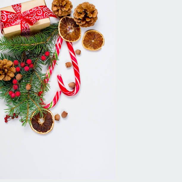 istock Gift box tied with a red ribbon , fir branches,candy 866099816