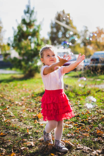 istock Cute girl playing with balloons 866099864