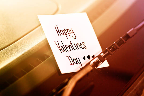A romantic note tucked under a car's windscreen wiper reads \