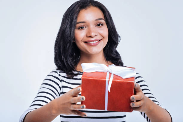 istock Cheerful woman handing a box with a present 866103846