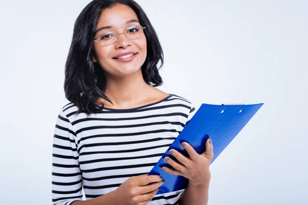 istock Cheerful woman holding a blue sheet holder 866104046