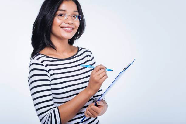 istock Cheerful woman making notes on sheet pinned to holder 866104218