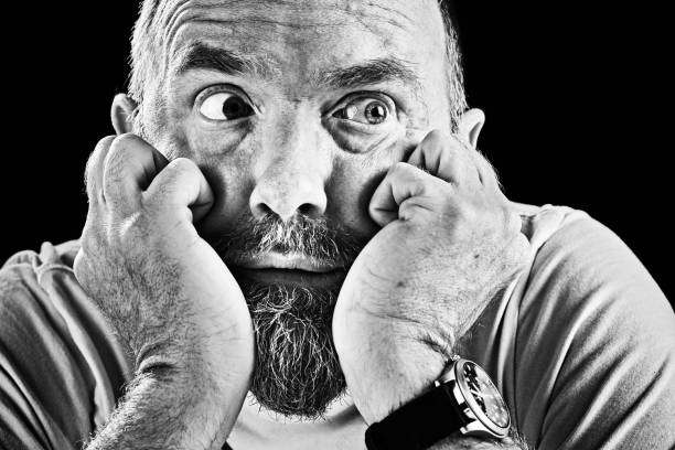 istock Anxious bearded mature man looks sideways, hads to his face 866106560