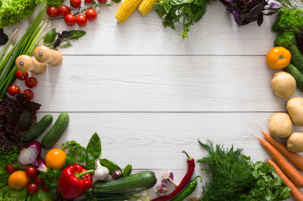 istock Frame of fresh vegetables on white wood background with copy space 866109046