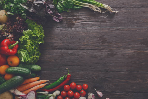 istock Border of fresh vegetables on wooden background with copy space 866109178